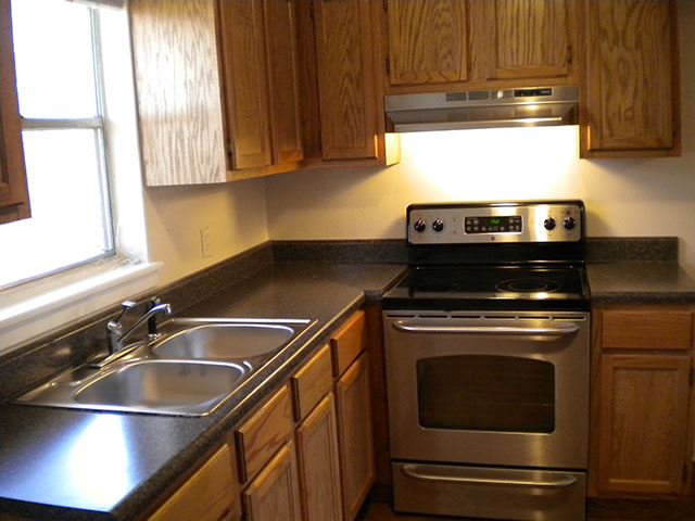 a kitchen with stainless steel appliances and wooden cabinets